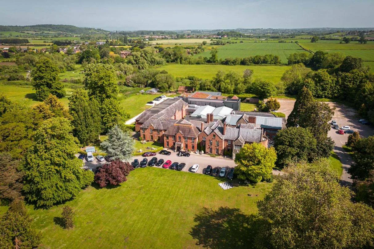 Aerial view of Hatherley Manor Hotel and its landscaped estate