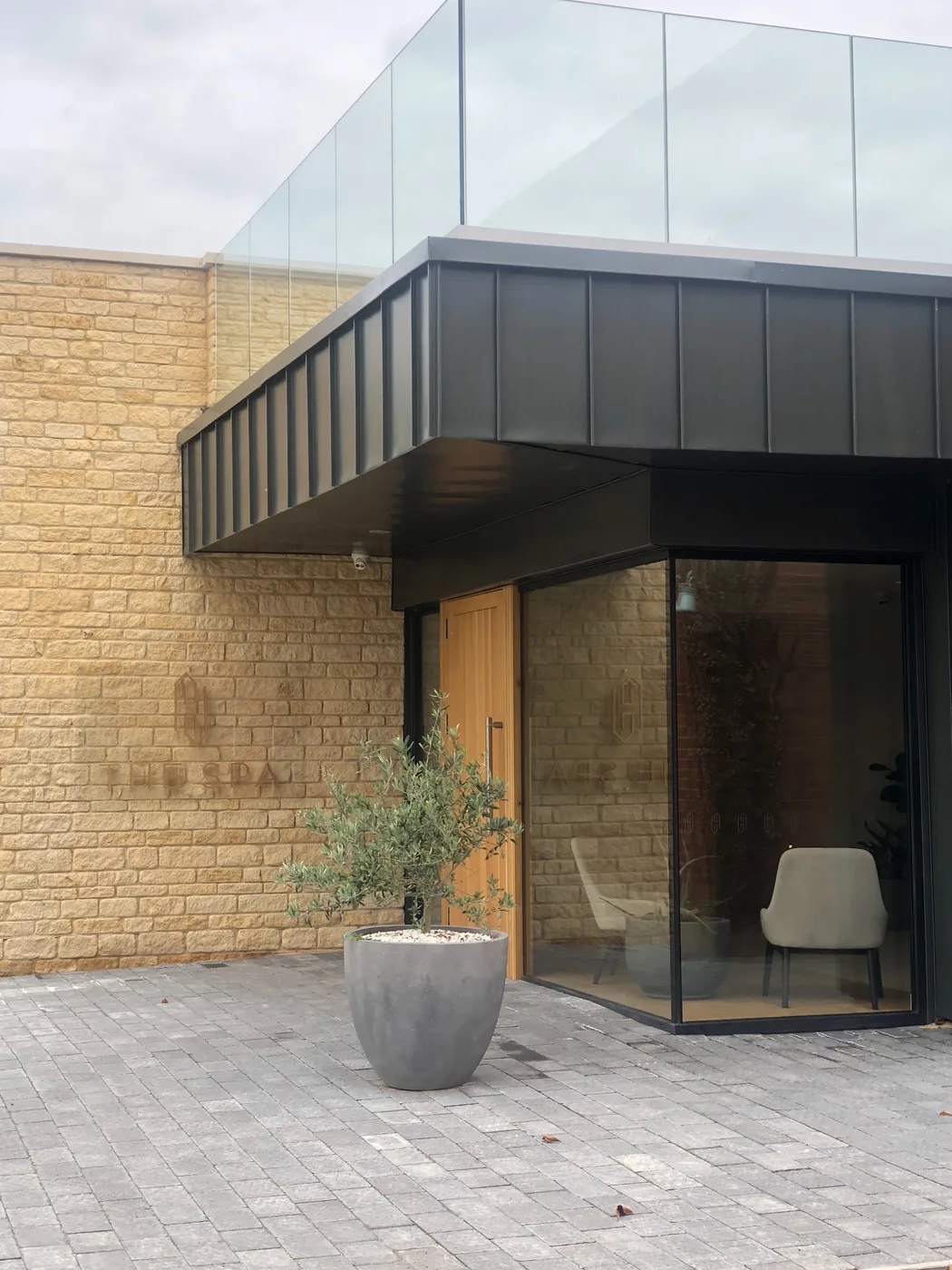 Detailed view of the spa entrance canopy and stonework