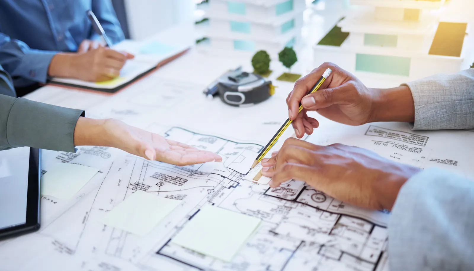 Architectural team reviewing plans and building models