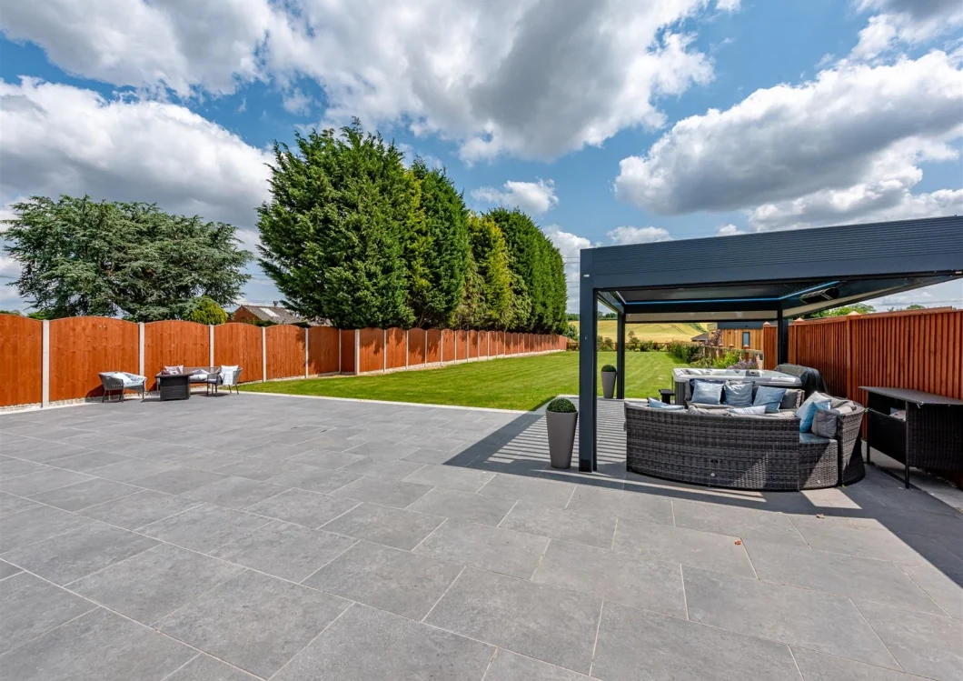 Private garden terrace and outdoor seating area serving an adjoining home