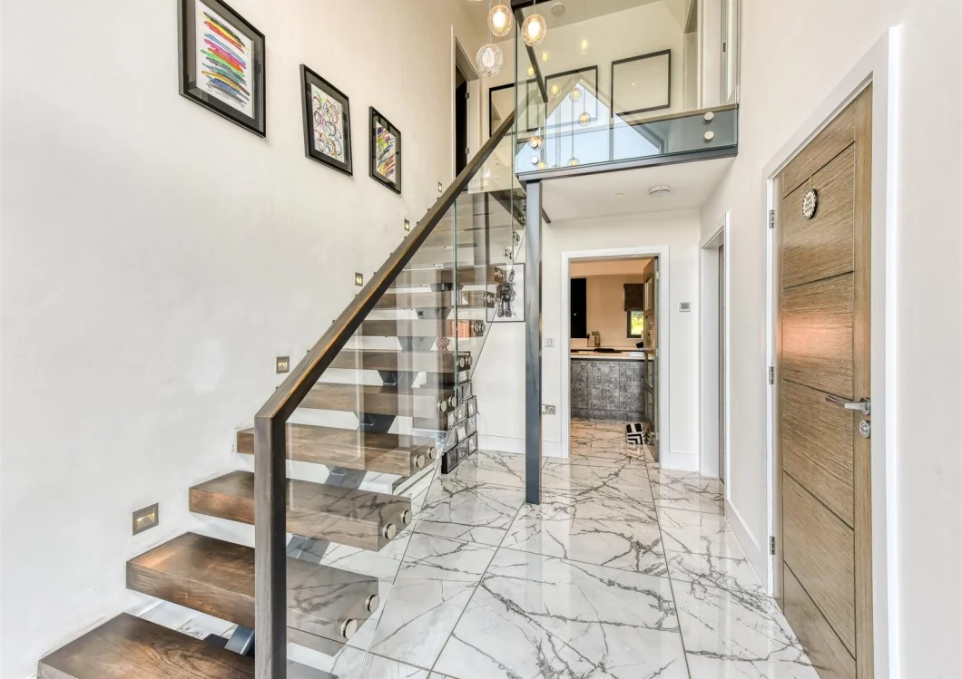 Open-tread staircase and double-height entrance hall within an adjoining home
