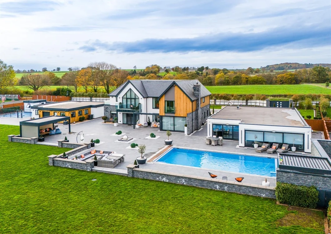 Aerial view of the completed Project 1257 residence, pool terrace and landscaped grounds