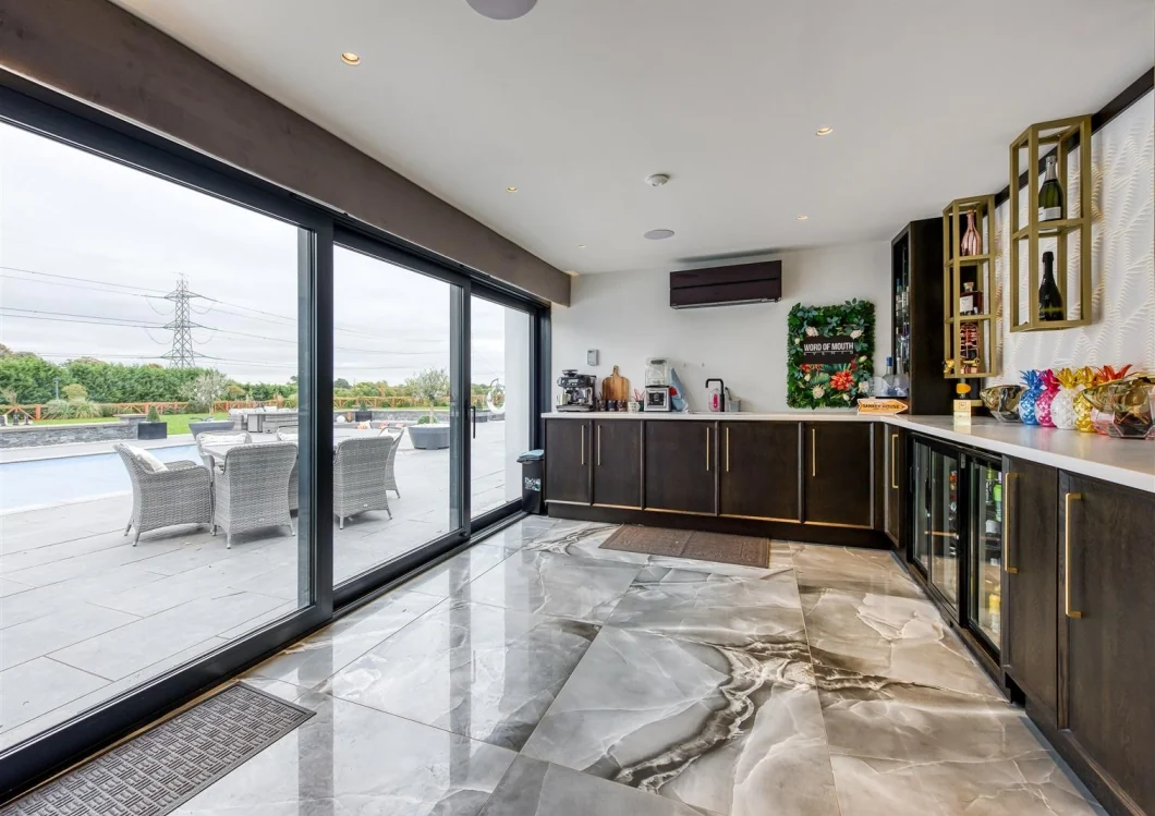 Garden bar opening onto the pool terrace and landscaped grounds