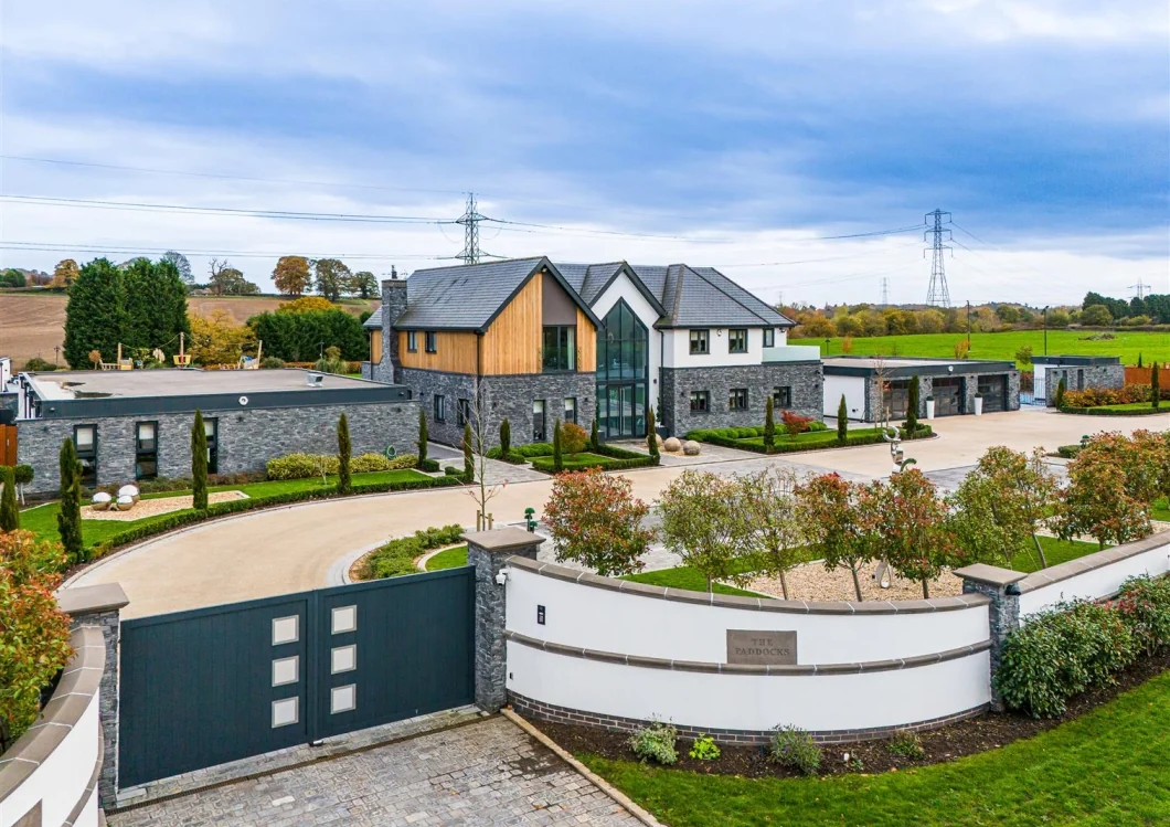 Aerial view of the entrance court, gates and formal landscaping